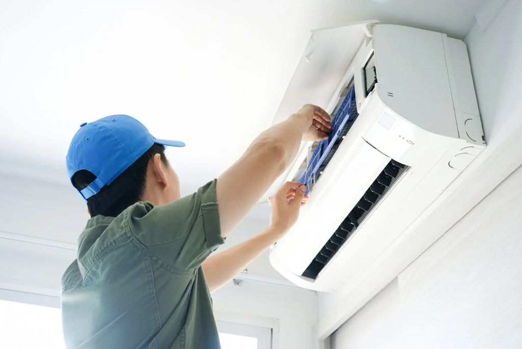 HVAC technician repairing air conditioner