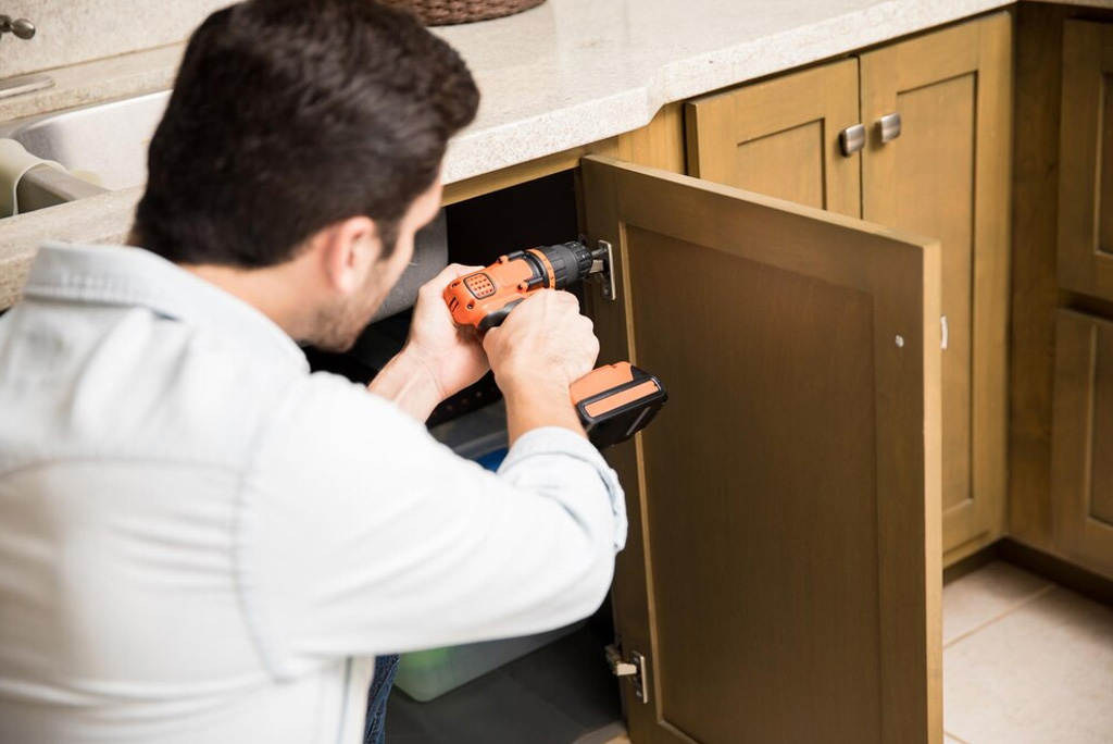 our carpenter repairing kitchen Cabinet